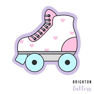 May include: A white roller skate with pink hearts and a pink and white boot. The wheels are blue and the skate has a light purple outline. The text "BRIGHTON Cutters" is at the bottom of the image.