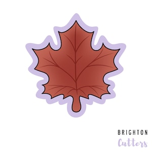 May include: A red maple leaf cookie cutter with a purple outline.  The cookie cutter is shaped like a maple leaf with five points.  Brighton Cutters is printed in purple text below the cookie cutter.