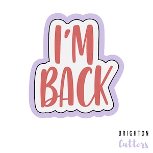 May include: A pink and white cookie cutter in the shape of a speech bubble with the text "I'M BACK" in a pink script font.