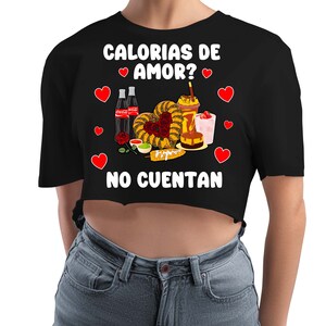 May include: Black cropped t-shirt with white text that reads "Calorias de Amor? No Cuentan" and a graphic of Mexican food and drinks with hearts.