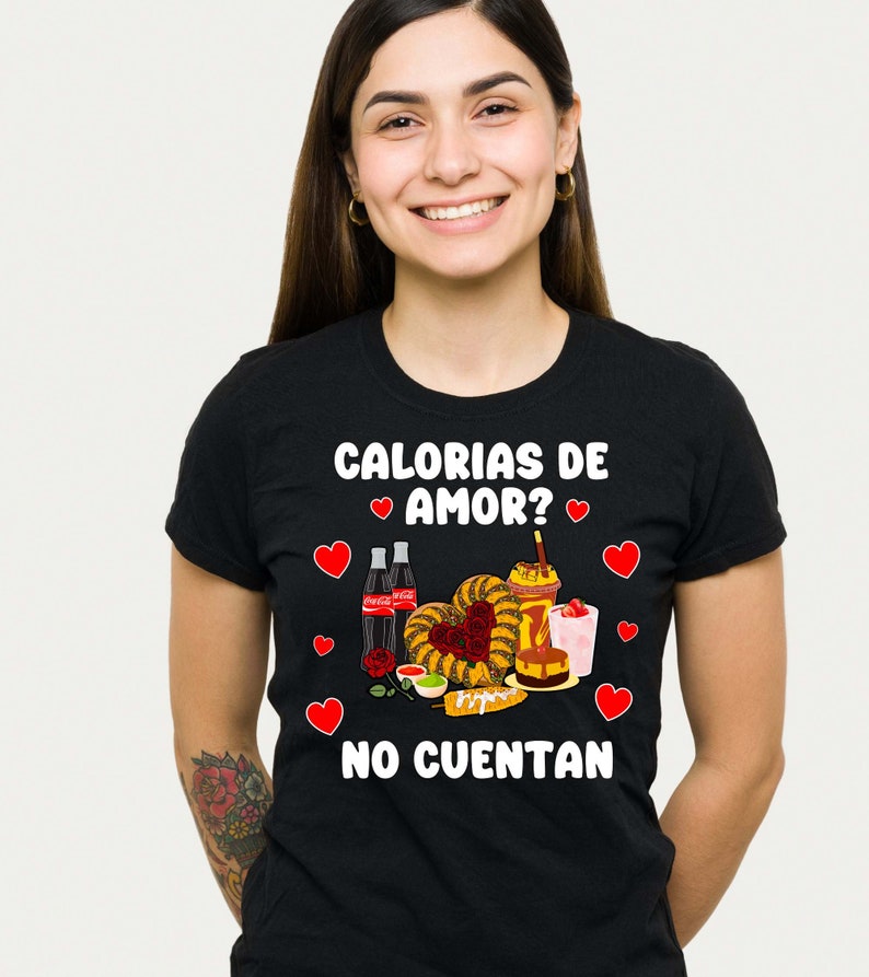 May include: Black t-shirt with a white graphic of Mexican food and the text "Calorias de amor? No cuentan".