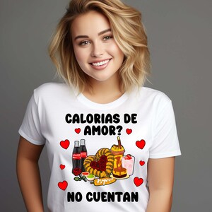 May include: White t-shirt with a graphic design featuring a variety of Mexican snacks and drinks, including churros, corn on the cob, and Coca-Cola. The text on the shirt reads "Calorias de amor? No cuentan".
