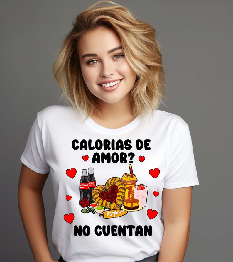May include: White t-shirt with a graphic design featuring a variety of Mexican snacks and drinks, including churros, corn on the cob, and Coca-Cola. The text on the shirt reads "Calorias de amor? No cuentan".