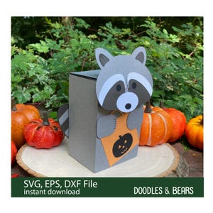 Halloween Raccoon Favor Treat Box - This Favor Treat Box has a cute gray raccoon with gray and white mask holding an orange bag with jack-o-lantern for trick-or-treating. Digital download SVG cut file for use with Cricut or Silhouette machines.