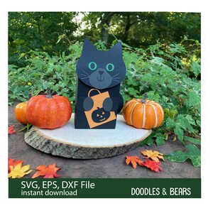 Halloween Black Cat Favor Treat Box - Cute black cat with green eyes holding an orange bag with jack-o-lantern for trick-or-treating is also a box for holding treats or favors. Digital download SVG file for use with Cricut or Silhouette machines.