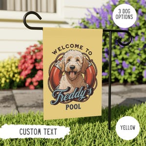 May include: A yellow welcome to the pool garden flag with a cartoon dog wearing a life preserver. The text on the flag reads "Welcome to Freddy's Pool".