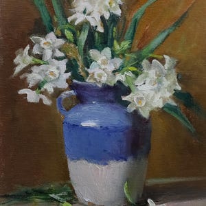 May include: Oil painting of white flowers in a blue and white ceramic pitcher. The flowers have green stems and leaves. The background is a warm, golden brown. The artist's signature is in the bottom left corner.