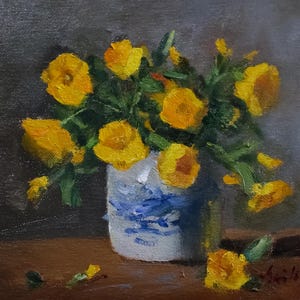 May include: An oil painting on canvas depicting a bouquet of vibrant yellow flowers in a white ceramic vase with blue painted details. The flowers have green leaves and stems. One yellow flower lies on the brown surface in front of the vase.