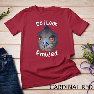 May include: A red t-shirt with a cartoon emu and the text "Do I look Emused".