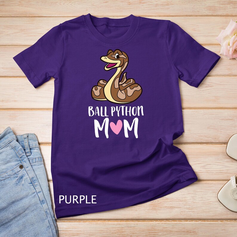 May include: Purple t-shirt with a cartoon ball python and the text "Ball Python Mom" with a pink heart.