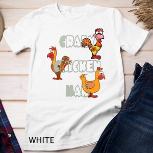 May include: White t-shirt with a graphic of three cartoon chickens and the text "Crazy Chicken Man".