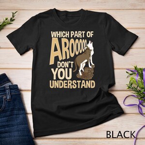 May include: Black t-shirt featuring the text "WHICH PART OF AROOOO DON'T YOU UNDERSTAND" and a graphic of a howling dog. The word "BLACK" is printed at the bottom of the shirt.