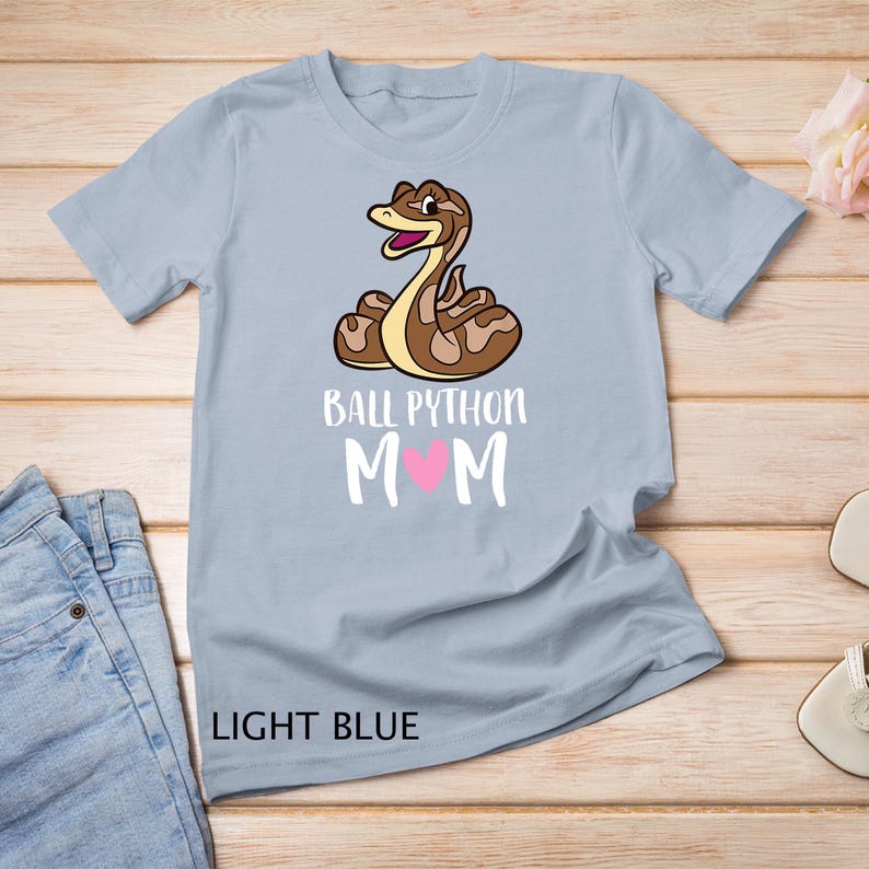 May include: Light blue t-shirt with a cartoon ball python and the text "Ball Python Mom" with a pink heart.