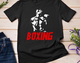 May include: Black t-shirt featuring a white silhouette of a boxer wearing boxing gloves and the word "BOXING" in red lettering.