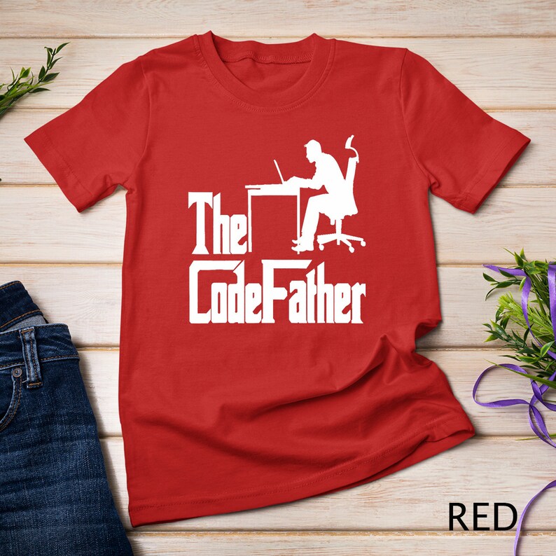 May include: Red t-shirt with a white silhouette of a person sitting at a desk with a laptop and the text "The CodeFather" in a stylized font.