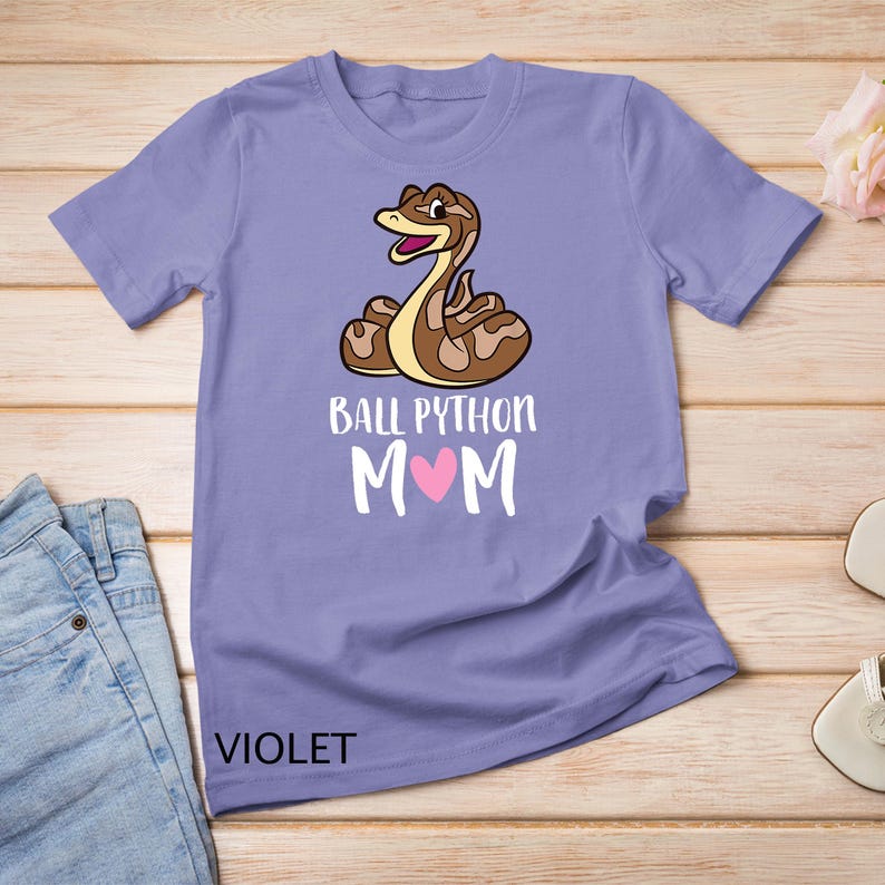 May include: A purple t-shirt with a cartoon ball python and the text "Ball Python Mom" with a pink heart.
