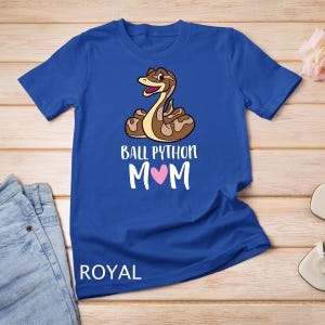 May include: Royal blue t-shirt with a cartoon ball python and the text "Ball Python Mom" with a pink heart.