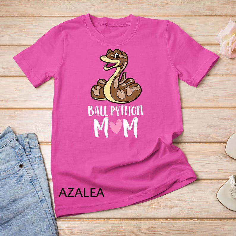 May include: Pink t-shirt with a cartoon ball python and the text "Ball Python Mom" with a pink heart.