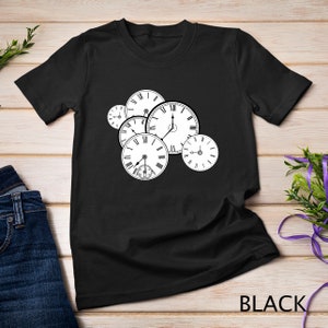May include: Black t-shirt featuring a cluster of white pocket watch illustrations with Roman numerals and hands indicating different times. The word "BLACK" is printed at the bottom of the shirt.