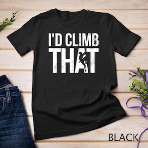 May include: Black t-shirt with white text that reads "I'd Climb That" and a silhouette of a person rock climbing.