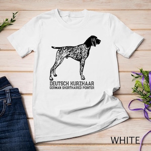 May include: White t-shirt with a black and white illustration of a German Shorthaired Pointer dog. The text "DEUTSCH KURZHAAR GERMAN SHORTHAIRED POINTER" is printed below the illustration.