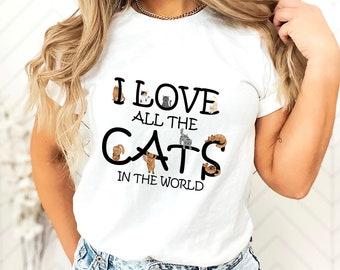 May include: White t-shirt with the text "I love all the cats in the world" and a graphic of several cats in different poses.