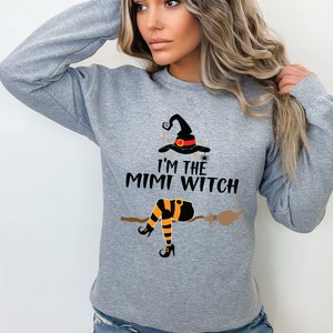 May include: Gray sweatshirt with a witch graphic and the text "I'm the Mimi Witch".