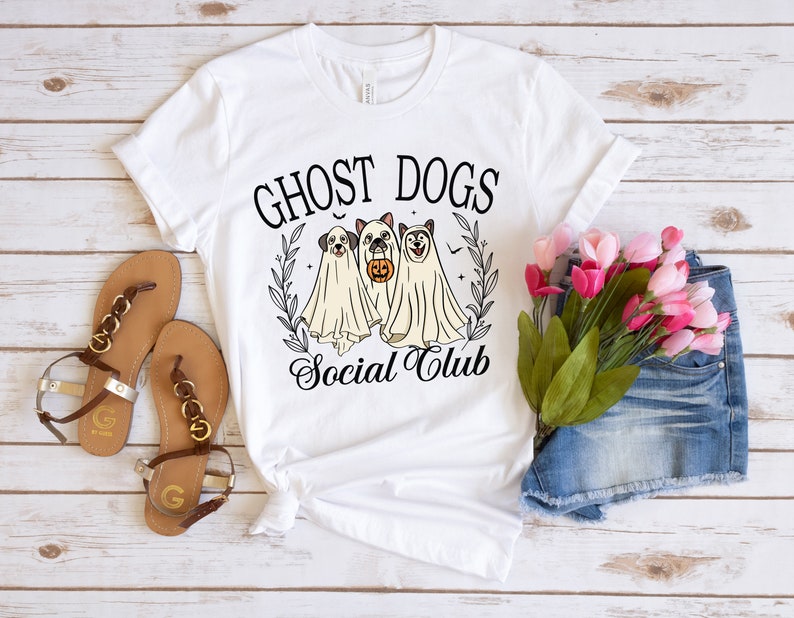 May include: White t-shirt with a black graphic of three ghost dogs with the text "Ghost Dogs Social Club".