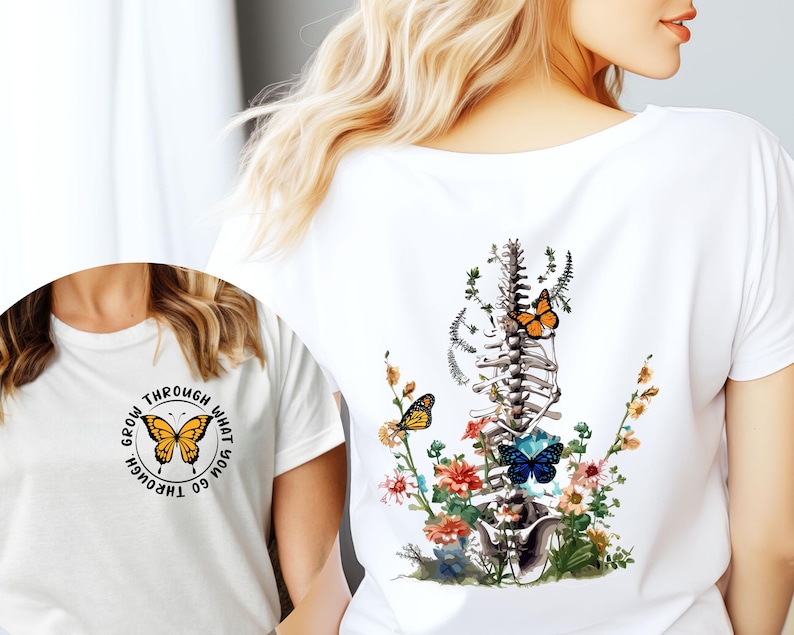 May include: White t-shirt with a graphic of a human spine with flowers and butterflies. The text "Grow through what you go through" is printed on the front of the shirt.