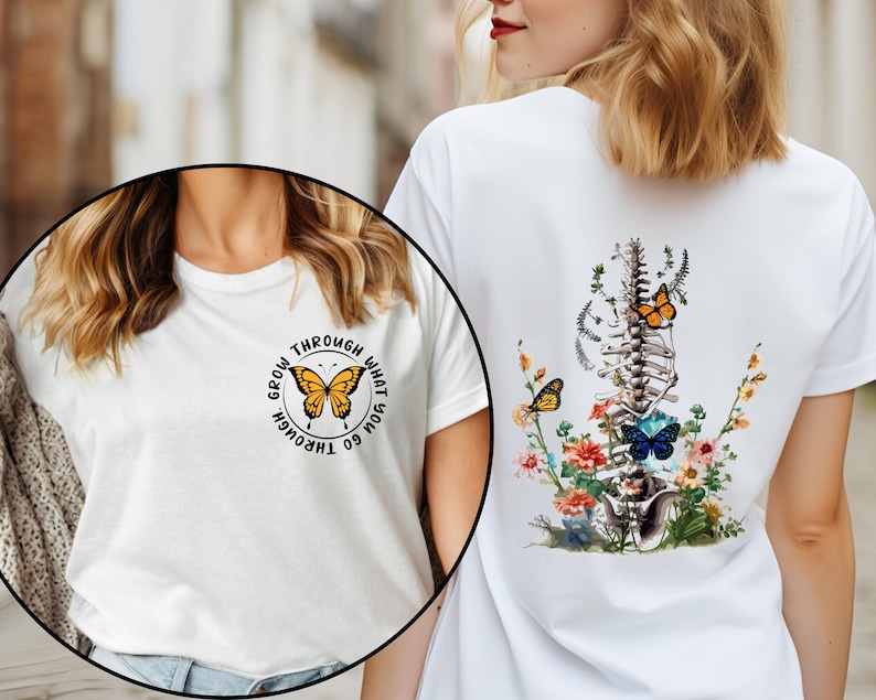 May include: Two white t-shirts with different designs. The first shirt has a butterfly graphic with the text "Grow through what you go through". The second shirt has a butterfly and floral design with a spine graphic.
