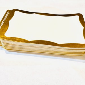 May include: A stack of gold-trimmed white stickers with the text "SLAP ADDICT STICKER CO." printed on the side.