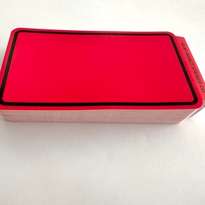 May include: A stack of red rectangular stickers with a black border. The stickers have the text "Slap Addict Sticker Co." printed on the side.