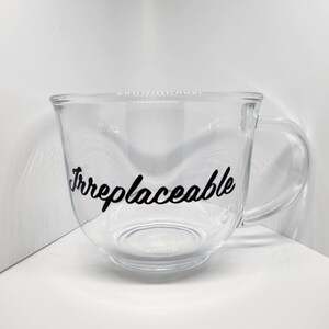 May include: A clear glass mug with a black vinyl decal that reads "Irreplaceable".