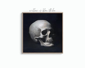 May include: A framed print featuring a detailed, realistic painting of a human skull. The skull is rendered in shades of white and gray against a dark background. The text "willow + blen studio" is in the upper right corner.