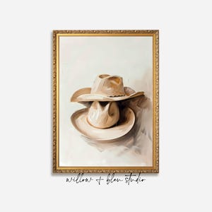 Rustic printable wall art featuring two cowboy hats in soft warm beige and brown tones — perfect for farmhouse, western, or cabin-inspired décor.