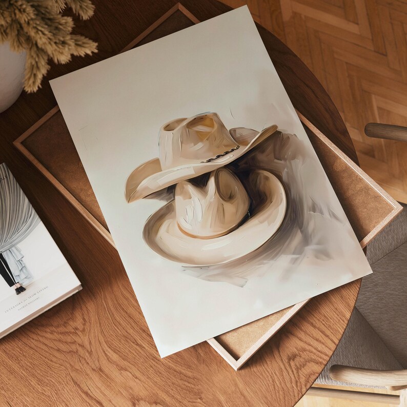 May include: A painting of two beige cowboy hats stacked on top of each other. The hats are painted in a realistic style with subtle brushstrokes.