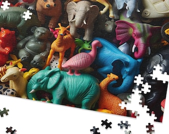 May include: A partially assembled jigsaw puzzle with a collection of animal figurines. The puzzle features a variety of animals, such as elephants, giraffes, and bears, in a range of colours. Some puzzle pieces are scattered around the main image, creating a playful scene.