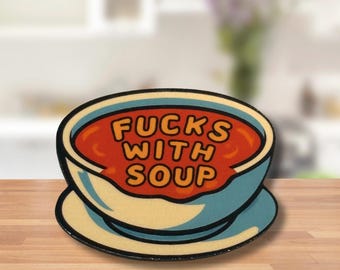 May include: A blue and white enamel pin shaped like a bowl of soup with the text "F*CKS WITH SOUP" in orange letters.