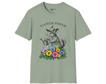 May include: Sage green t-shirt with a graphic of a chinchilla wearing a hat and overalls, watering a bed of colorful flowers. The words "FLOWER POWER" are arched above the chinchilla. The shirt is a crew neck style.