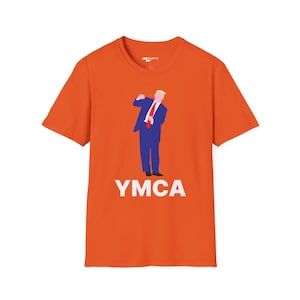 May include: Orange t-shirt with a cartoon image of a person in a blue suit and red tie, doing the YMCA dance move. The text "YMCA" is printed in white below the image.