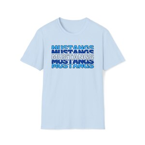 May include: A light blue t-shirt with the word "MUSTANGS" repeated five times in a stacked design. The text is in a blue and white color scheme.