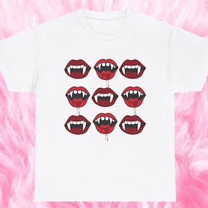 May include: White t-shirt with a repeating pattern of nine red vampire mouths with fangs and dripping blood.
