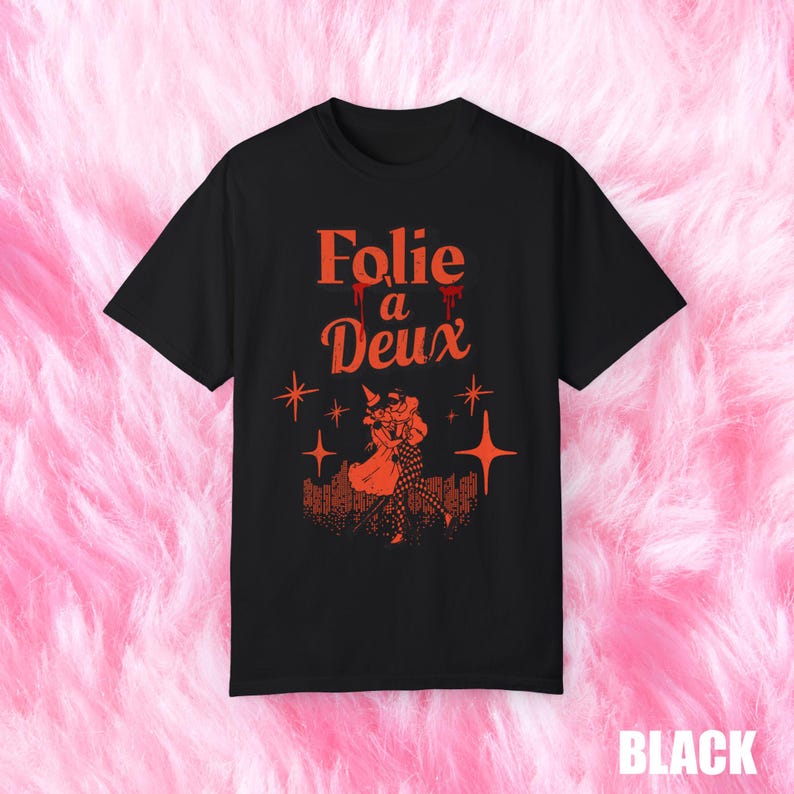 May include: Black t-shirt with a red graphic print of a couple dancing. The text "Folie a Deux" is printed in red above the couple.