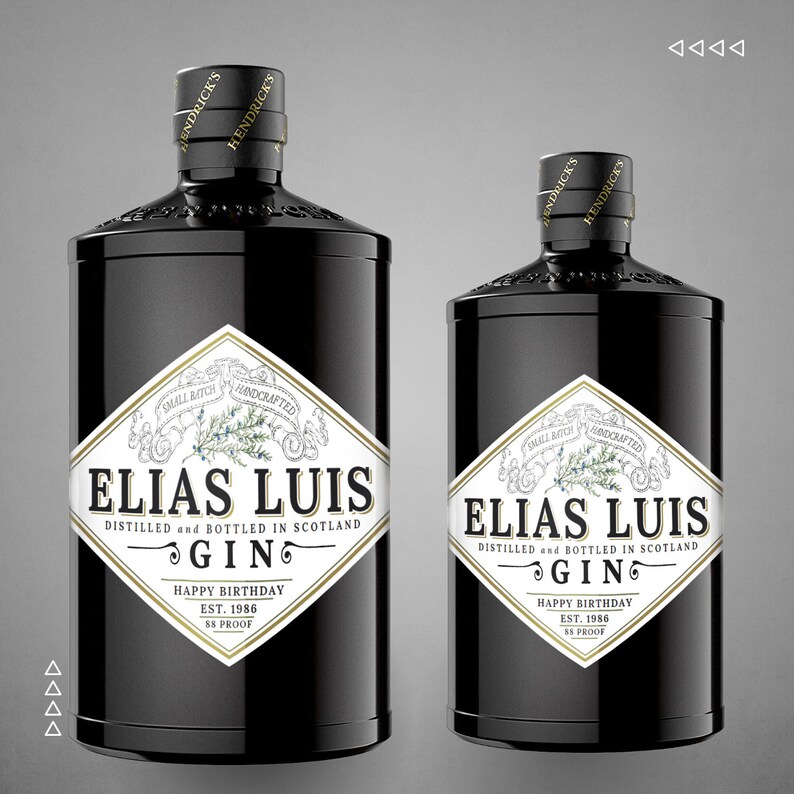 Pode incluir: Duas garrafas de gin de vidro preto com r&oacute;tulos dourados. Os r&oacute;tulos apresentam o texto "Elias Luis Gin" e "Feliz anivers&aacute;rio Est. 1986 88 Proof".