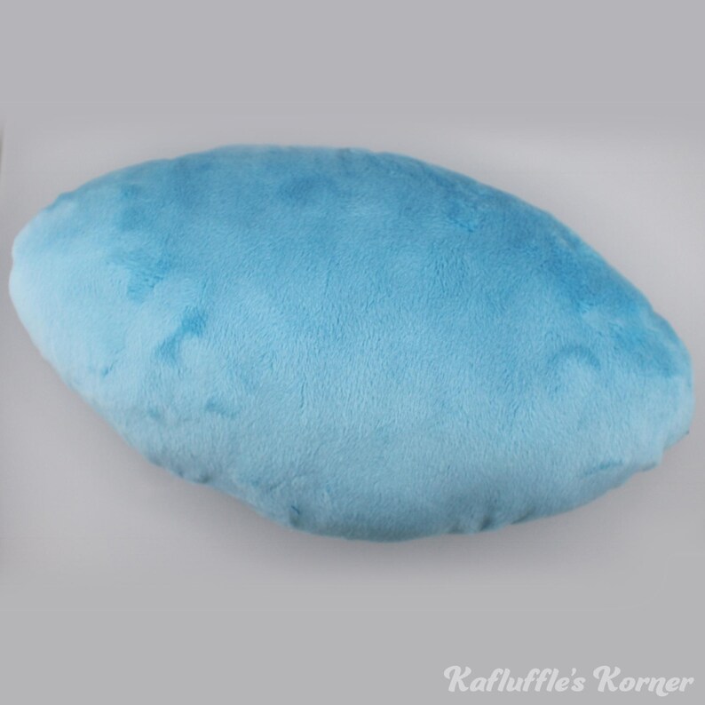 May include: A light blue, cloud-shaped plush pillow. The pillow has a soft, velvety texture and is a solid colour. The pillow is a light blue colour and is a solid shape. The text "Kafluffle's Korner" is in the bottom right corner.