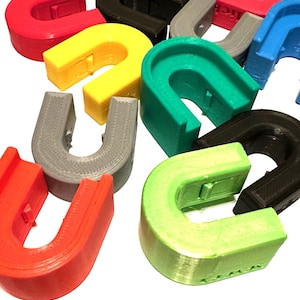 May include: A collection of colorful U-shaped plastic pieces. The pieces are in various colors, including red, yellow, green, blue, gray, and black.
