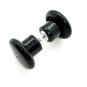May include: Two black ceramic knobs with a silver screw connecting them. The knobs are round and have a smooth, glossy finish.