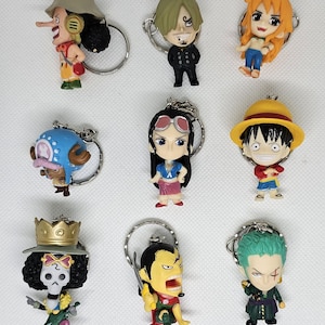 Puede incluir: Un conjunto de nueve llaveros de personajes de anime coloridos. Los personajes son de la popular serie de anime One Piece. Los llaveros están hechos de plástico y presentan una variedad de personajes, incluidos Luffy, Zoro, Nami, Usopp, Sanji, Chopper, Robin, Franky y Brook.