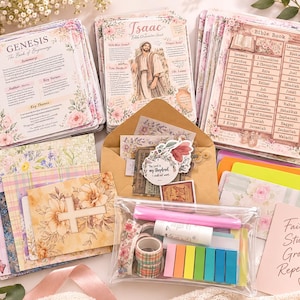 May include: A collection of Bible study cards featuring floral designs, including Genesis and Isaac character summaries, a Bible book list, a cross illustration, a brown envelope with stickers, a clear pouch with washi tape, and a pink card with the text Faith Study Grow Repeat.