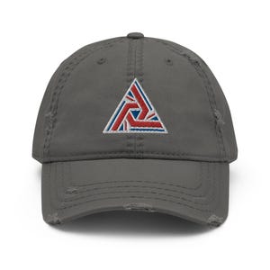 May include: A grey distressed baseball cap with a red, white and blue embroidered triangle logo.